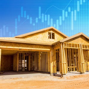 A home under construction and a stock ticker 