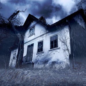 A spooky house with stormy skies above.