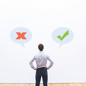 A businessman looks at a wall with yes and no options