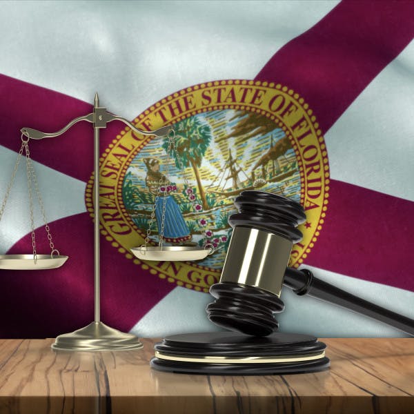 Judge's gavel, scales of justice and Florida flag