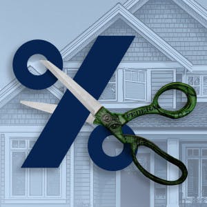 Scissors cutting through percentage sign with house in background