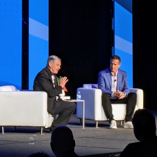 Stefan Swanepoel and eXp founder Glenn Sanford on stage at the T3 Leadership Summit in Scottsdale, AZ, on April 23.