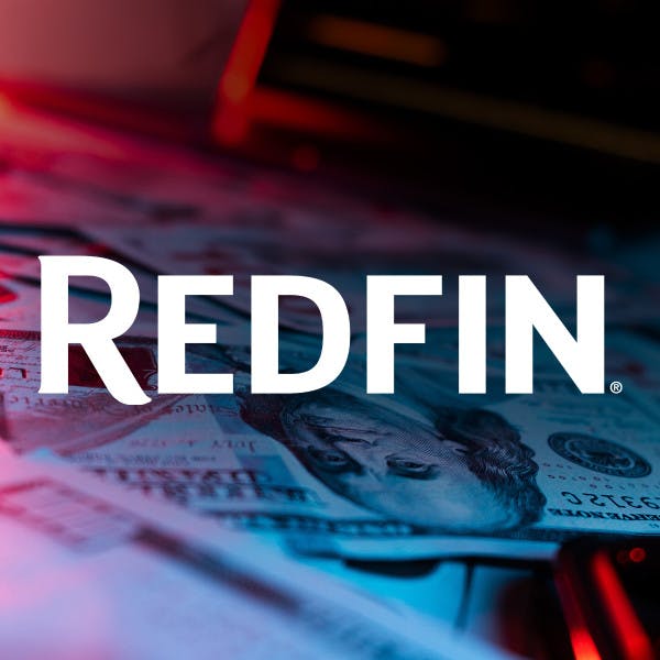 Redfin logo and $100 bills on a table.