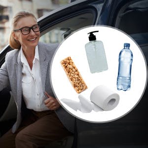 A real estate agent has a granola bar, hand sanitizer, bottled water and toilet paper in her car.