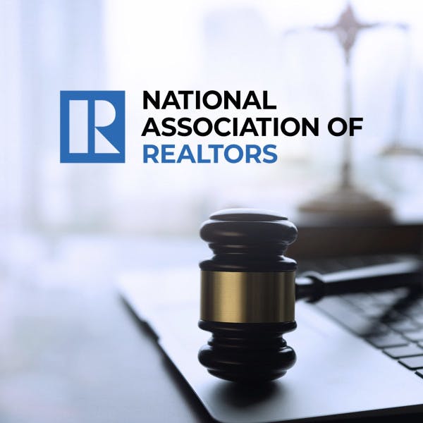The National Association of Realtors logo and a gavel on a laptop.