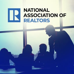 National Association of Realtors logo and business people in a conference room.