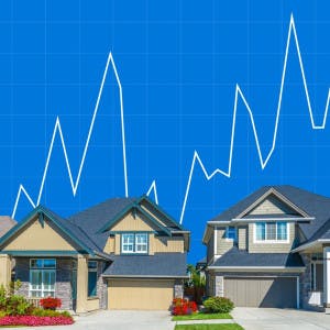 Suburban homes against a backdrop of a fluctuating line graph.