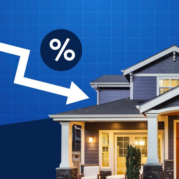 A down arrow pointing at a house representing falling mortgage rates.