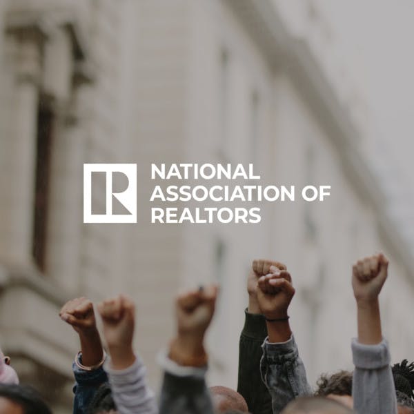 The National Association of Realtors logo against the backdrop of a protest.