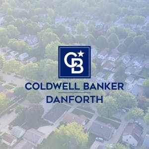 Coldwell Banker Danforth logo over an aerial view of houses.