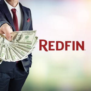 A businessman with a handful of cash and the Redfin logo