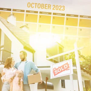 A family stands outside their new home, with a calendar showing the month of October in the background.