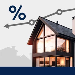 A line graph above a house points down to reflect a drop in mortgage interest rates.
