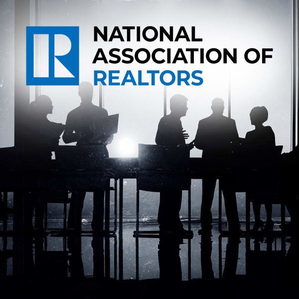 Silhouettes of a group of business people with the National Association of Realtors logo.
