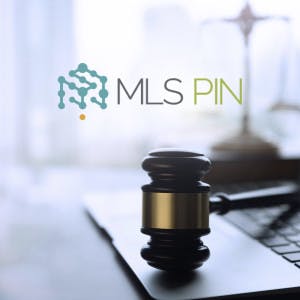MLS PIN logo and a gavel on a laptop