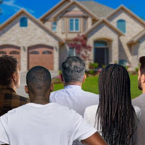 A diverse group of people stand facing a home