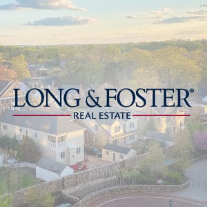 Long and Foster logo overlayed on aerial view of houses
