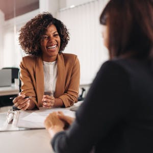 Agent recruiting: Two women smiling at each other