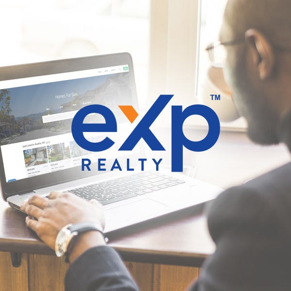 eXp realty logo over image of man on laptop 