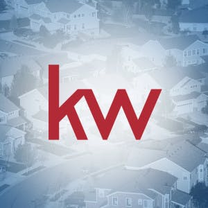 Keller Williams logo over an aerial view of suburban homes
