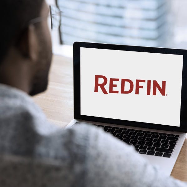 Man on laptop with Redfin logo on screen