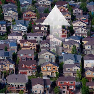 An aerial view of homes and an up arrow