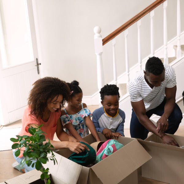 African American family packing things in home
