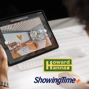 Howard Hanna and ShowingTime+ logos with a home shopper looking at an interactive listing image on her tablet.