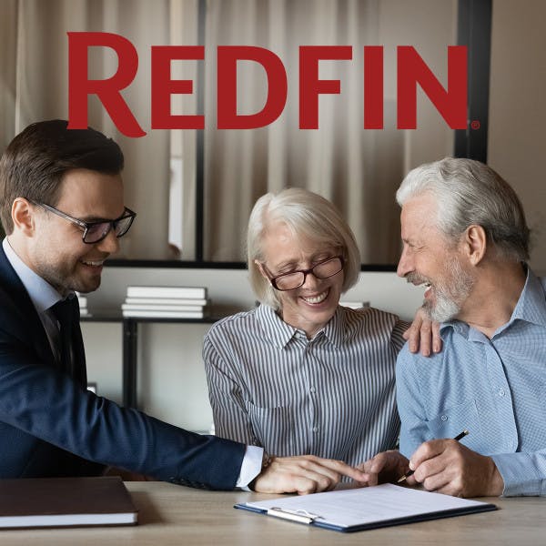 The Redfin logo and a couple signing papers with a real estate agent.