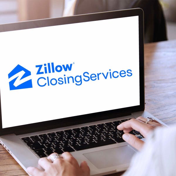 A laptop with Zillow Closing Services on the screen.
