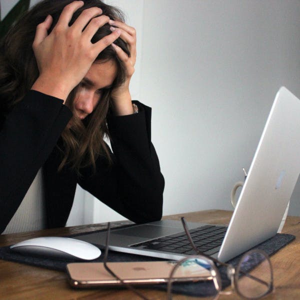 Frustrated woman looking at laptop