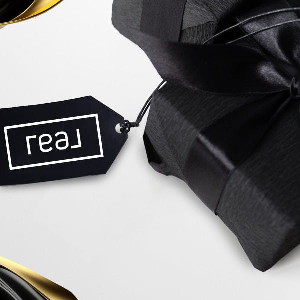 Real Brokerage logo on a gift tag