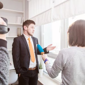 Sharing expertist: man being interview by woman 