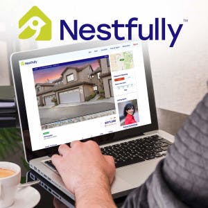 A laptop displays the home page of consumer home search site Nestfully.