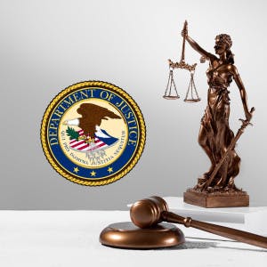 The Department of Justice seal, a gavel and the scales of justice.
