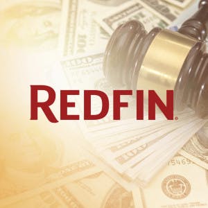 Redfin logo and a gavel on a pile of hundred-dollar bills